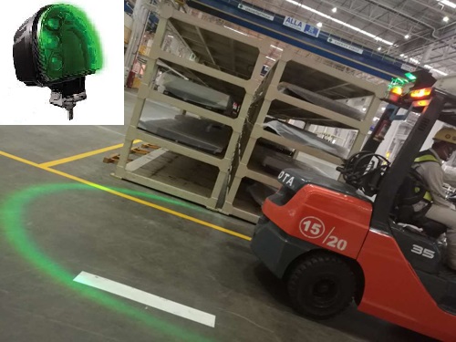 A Toyota forklift operator using a green light in a well-lit environment to indicate to other workers where the safe distance is.